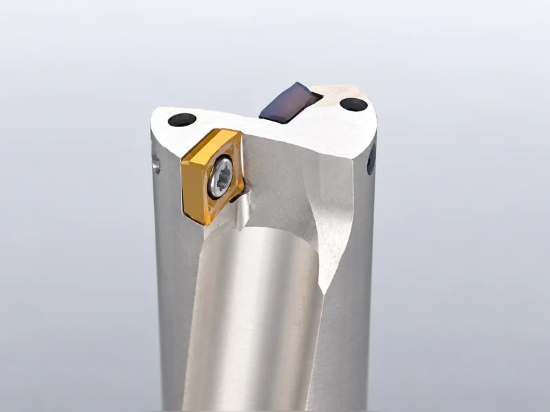 Close-up of an indexable drill body and its separate cutting inserts.