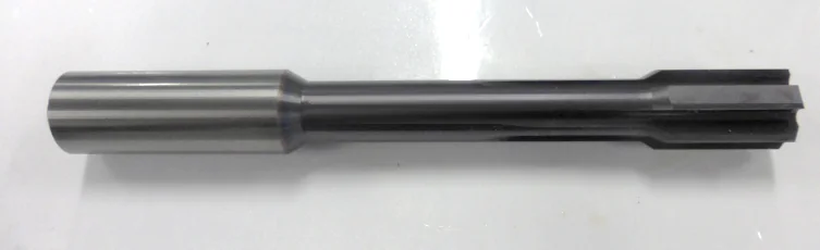 Solid carbide reamer photographed in the reported tooling set