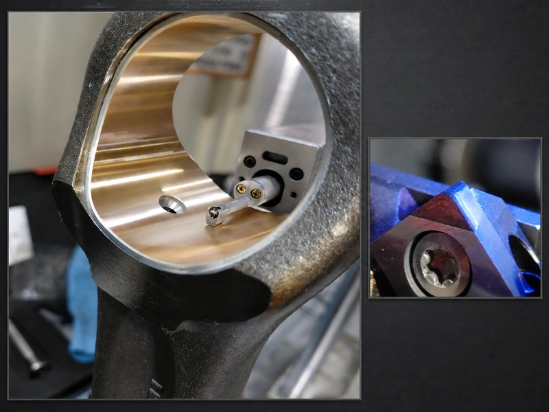 Brass steering-knuckle bushing bore with an internal machining tool and a close-up inset of the cutting insert.