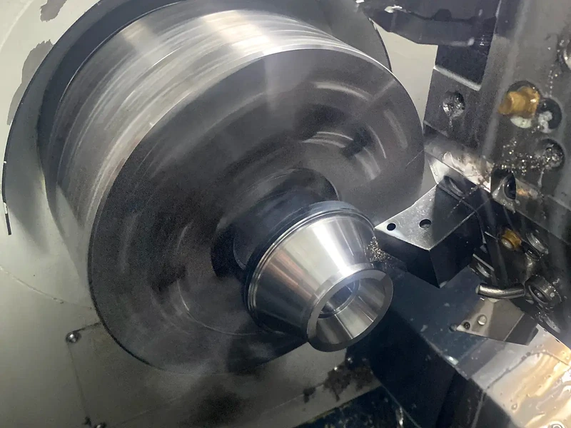 CBN insert hard turning a hardened steel component inside a CNC lathe.