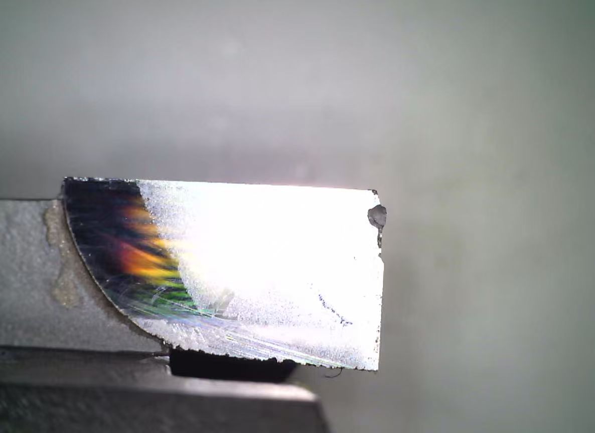 Close view of a milling cutter edge with an observed worn condition.