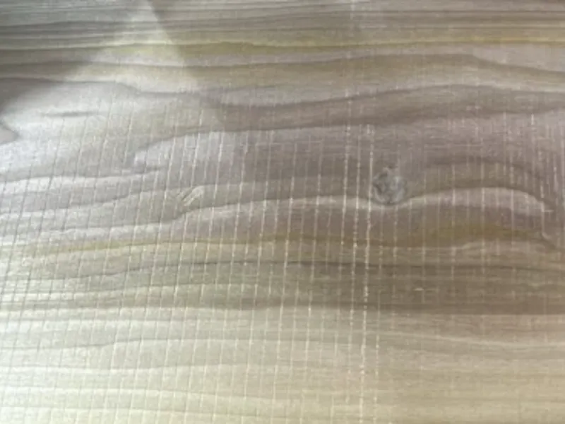 Repeated surface lines visible on wood under raking light