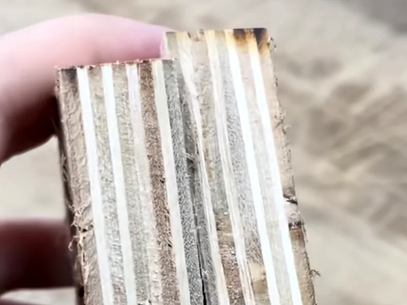 A profiled wooden edge with localized dark marks