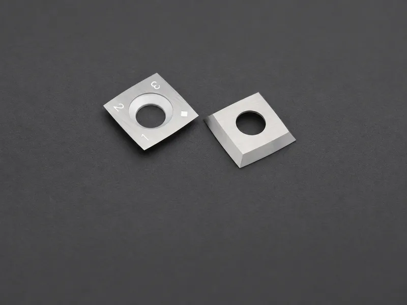Two square indexable cutting inserts with center holes