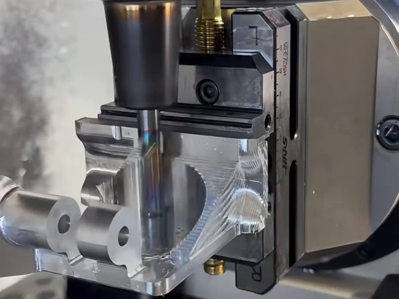 A milling tool machining a clamped metal workpiece