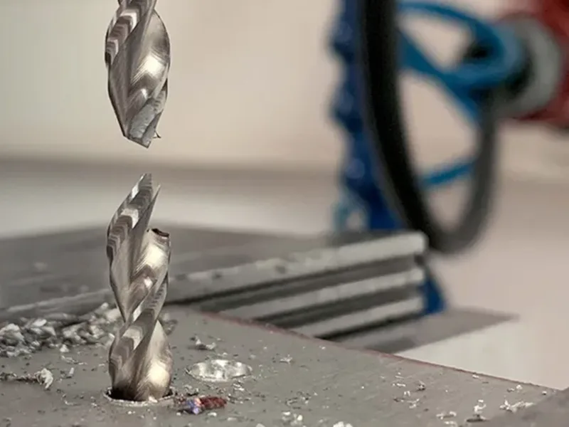 A separated drill above a broken section at the workpiece