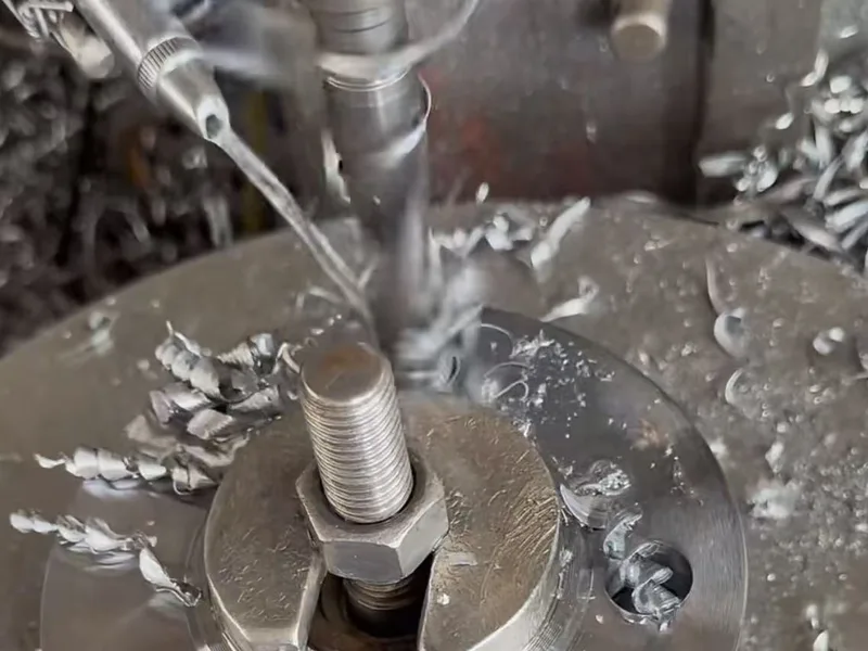 Drilling area with visible chips around the workpiece